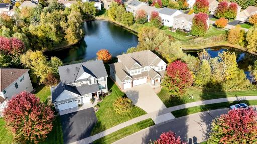 The inviting front exterior features an expansive concrete driveway and beautiful landscaping, setting the stage for this exceptional Blaine home.