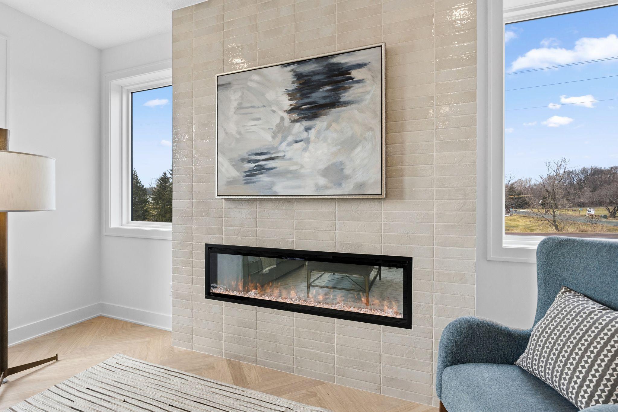 Floor to ceiling ceramic tile surrounding an electric fireplace