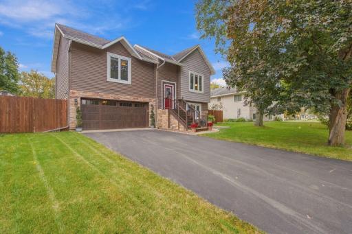 Newer asphalt drive way and updated siding with natural stone