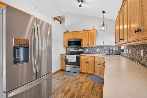 Spacious kitchen with abundant cabinetry, generous counter space, and stainless-steel appliances.