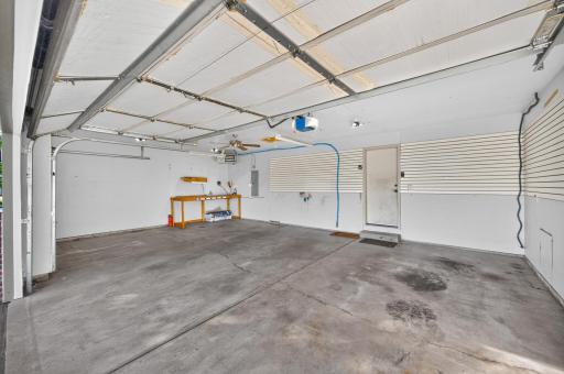 Oversized three-car heated and insulated garage with plenty of room for vehicles, storage and a workbenchâplus wall-mounted storage panels and convenient access to the home.