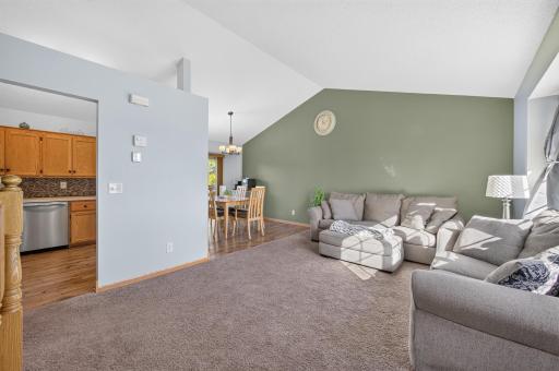Just a half a level up you have a bright and spacious living room with vaulted ceiling and an open flow to the kitchen and dining area.