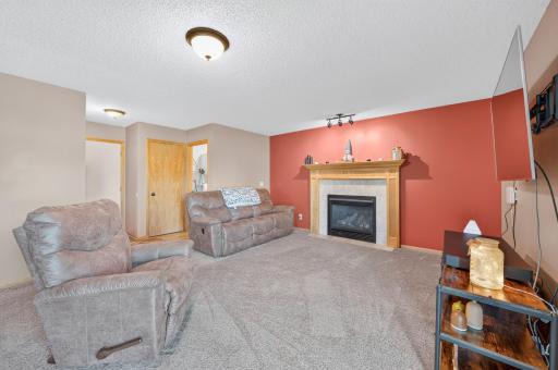 Cozy main-level family room centered around a beautiful gas fireplaceâperfect for relaxing or entertaining.