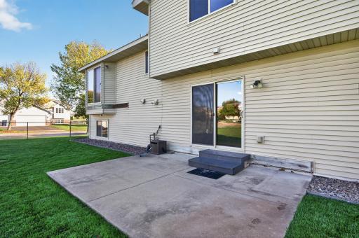 Spacious backyard patio provides plenty of room for outdoor dining, grilling and entertaining, all overlooking the large, fully fenced backyard.