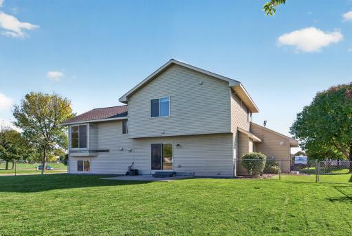 Rear exterior view showcases the spacious fenced backyard, concrete patio and plenty of green space for outdoor fun, pets and entertaining.