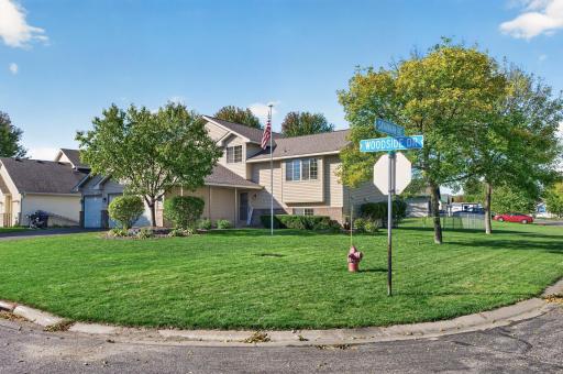 Beautiful corner lot with mature trees, manicured lawn, and great curb appeal.