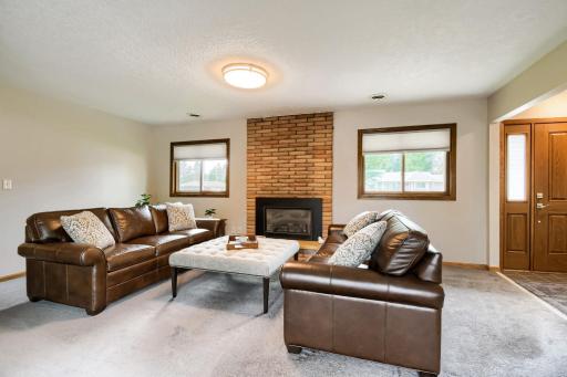 Main floor family room features a newer efficient gas fireplace