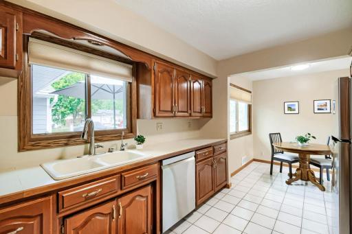 Kitchen overlooks the large deck & fenced backyard