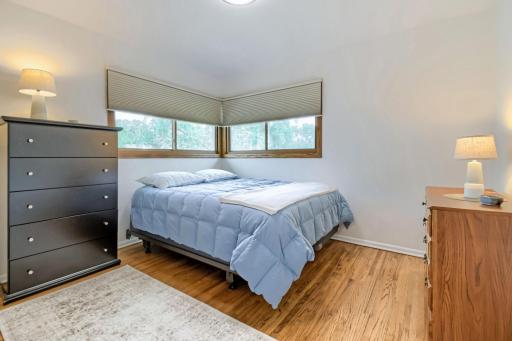 Bedroom #2 of the 4 main floor bedrooms--note the beautifully finished hardwood floors & new windows
