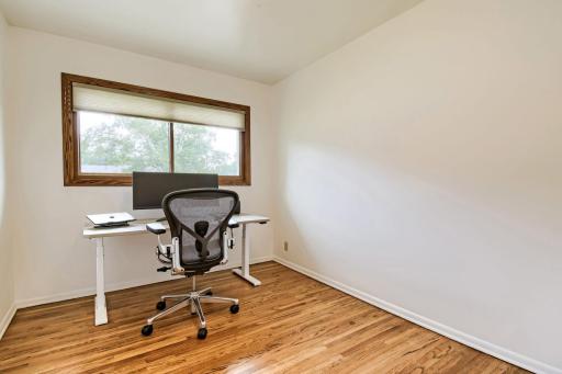 Bedroom #3 of 4 main floor bedrooms currently used as an office--note the beautiful freshly finished hardwood floors