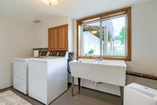 Nicely placed laundry room at the foot of the stairs--note the large window & lockable dry storage under the deck