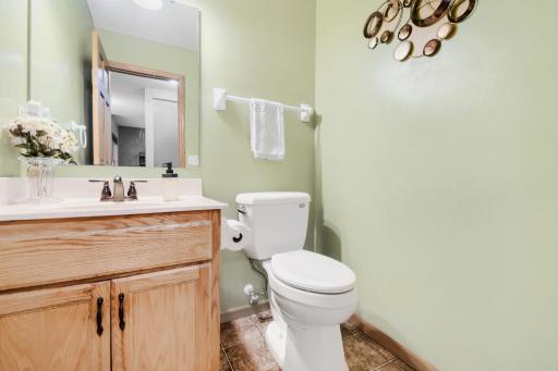 Convenient main-level half bath featuring a clean, functional layout and warm wood vanity. Ideally located for guests and everyday use.