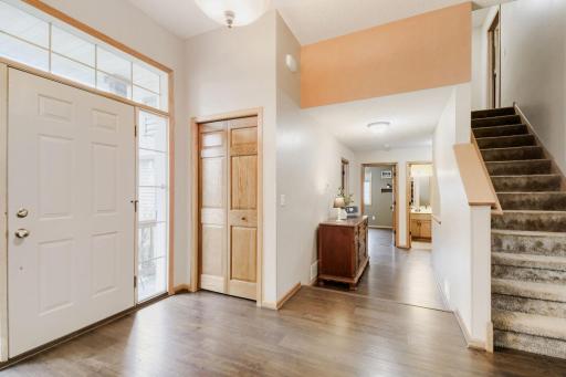 Bright and welcoming entryway featuring abundant natural light. An open layout provides a seamless view into the main living areas of the home.