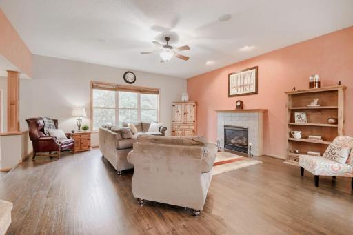 Spacious living room featuring a cozy gas fireplace and plenty of natural light. The open layout offers ample space for relaxing, entertaining, and gathering with family and friends.