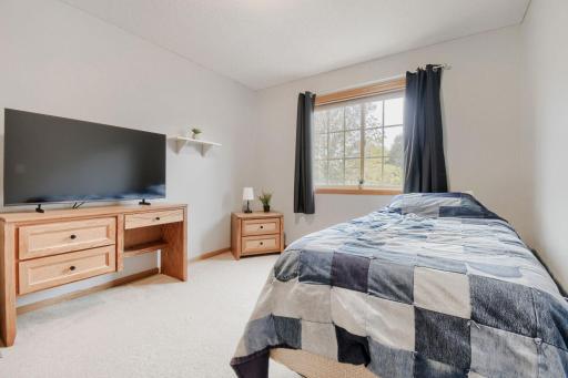 Spacious bedroom featuring a large window that brings in plenty of natural light. The generous layout offers ample room for bedroom furniture and additional storage.