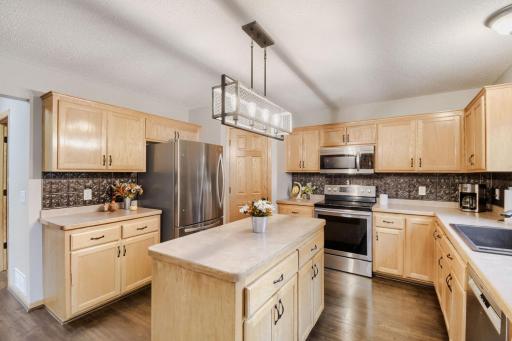 Spacious kitchen featuring a center island, abundant cabinetry, and stainless steel appliances. Ample counter space and an open layout make it ideal for cooking and entertaining.