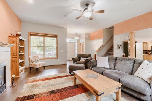 Another view of the spacious living room highlights the open layout and abundant natural light. The warm flooring and comfortable gathering space create an inviting atmosphere for everyday living.