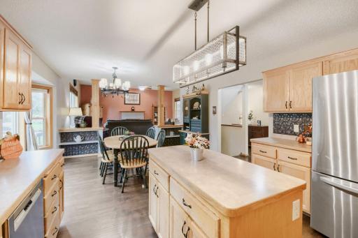 The kitchenâs open design creates a seamless connection to the dining area, perfect for everyday living and gatherings. A large center island provides additional workspace and a natural focal point for the room.