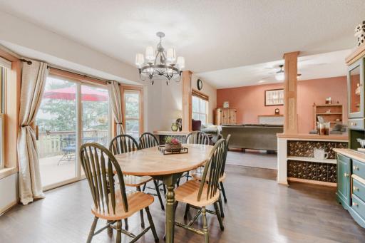 Another view of the informal dining area showcases its open connection to the kitchen and surrounding living spaces. Large sliding glass doors provide natural light and convenient access to the deck.