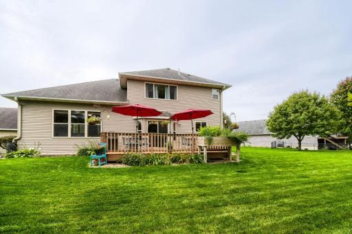 Spacious backyard featuring a large deck with plenty of room for outdoor dining, grilling, and entertaining. The expansive lawn provides additional space to relax, play, and enjoy the outdoors.