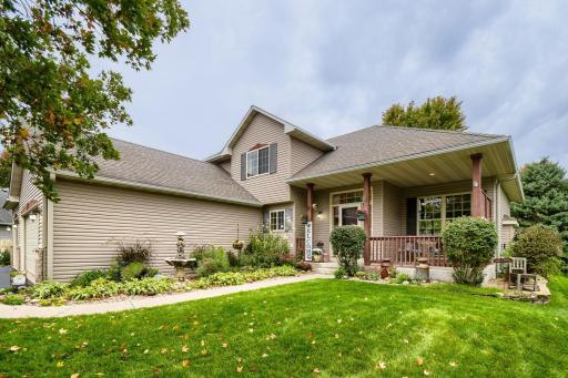 Beautifully maintained home with charming curb appeal, mature landscaping, and a welcoming covered front porch. The lush lawn and inviting entrance create a warm first impression.