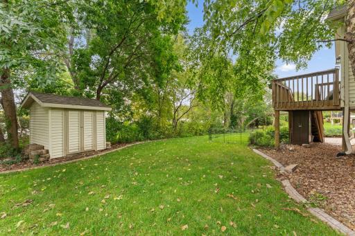 Backyard shed. Concrete curbing featured throughout property.