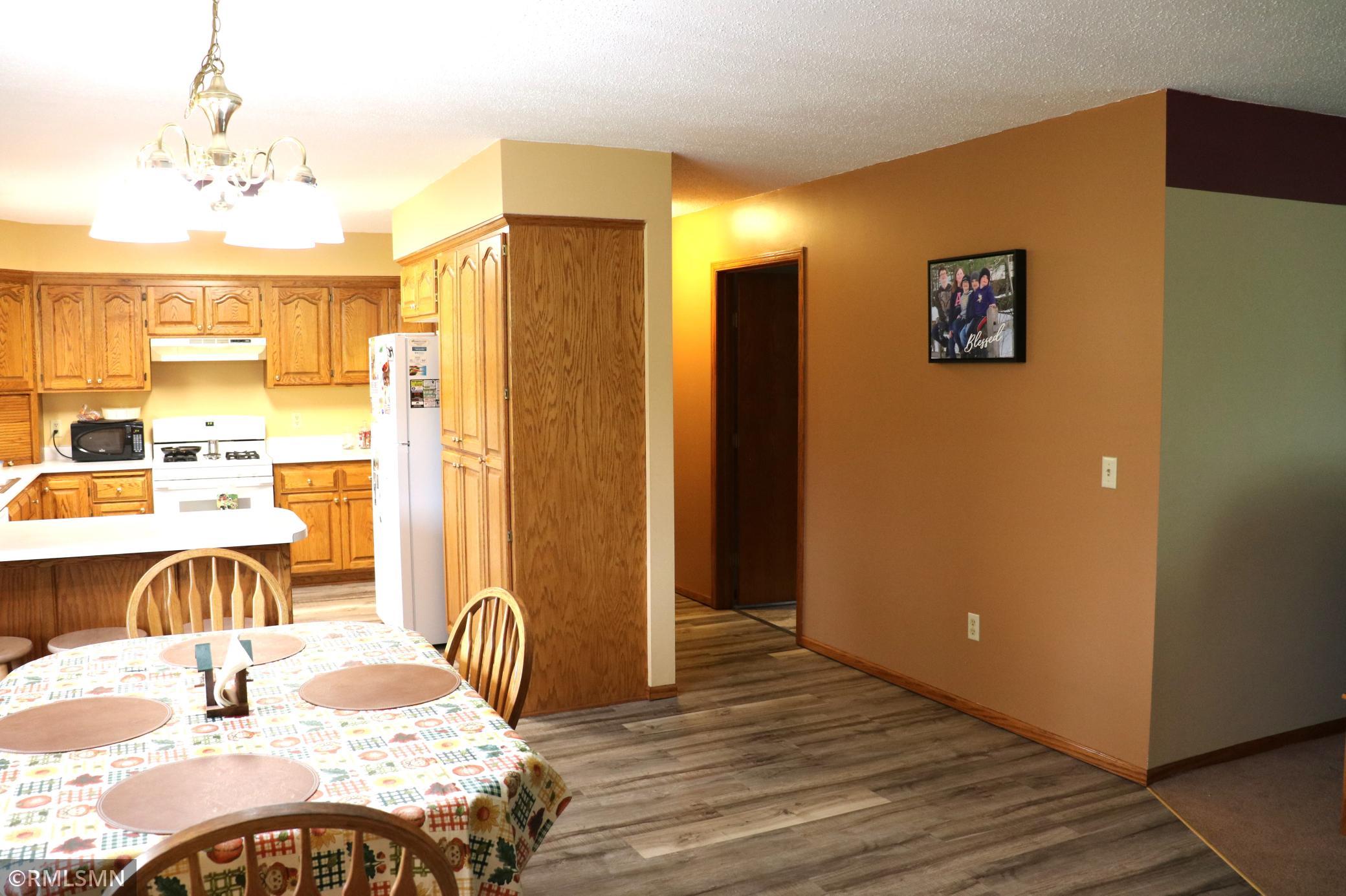Hallway to garage, 2nd bath and laundry/utility area