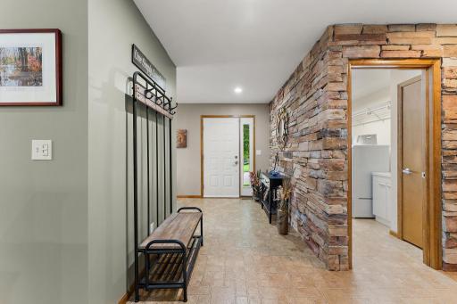 Entryway offers lots of room for guests to enter. Plus a stone wall adds to the unique decor~