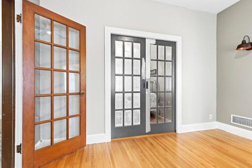 One of 2 main floor bedrooms with french doors