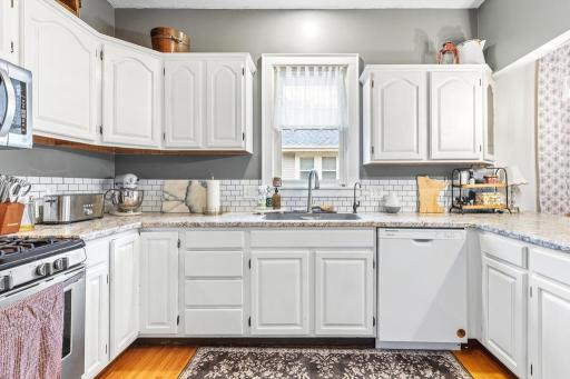 Stunning kitchen with white subway tile backsplash complimenting the newly painted white cabinetry. New dishwasher also installed recently.