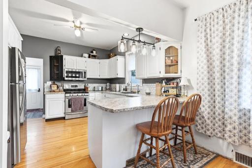 Step inside and be charmed by tasteful updates and stunning wood floors throughout!