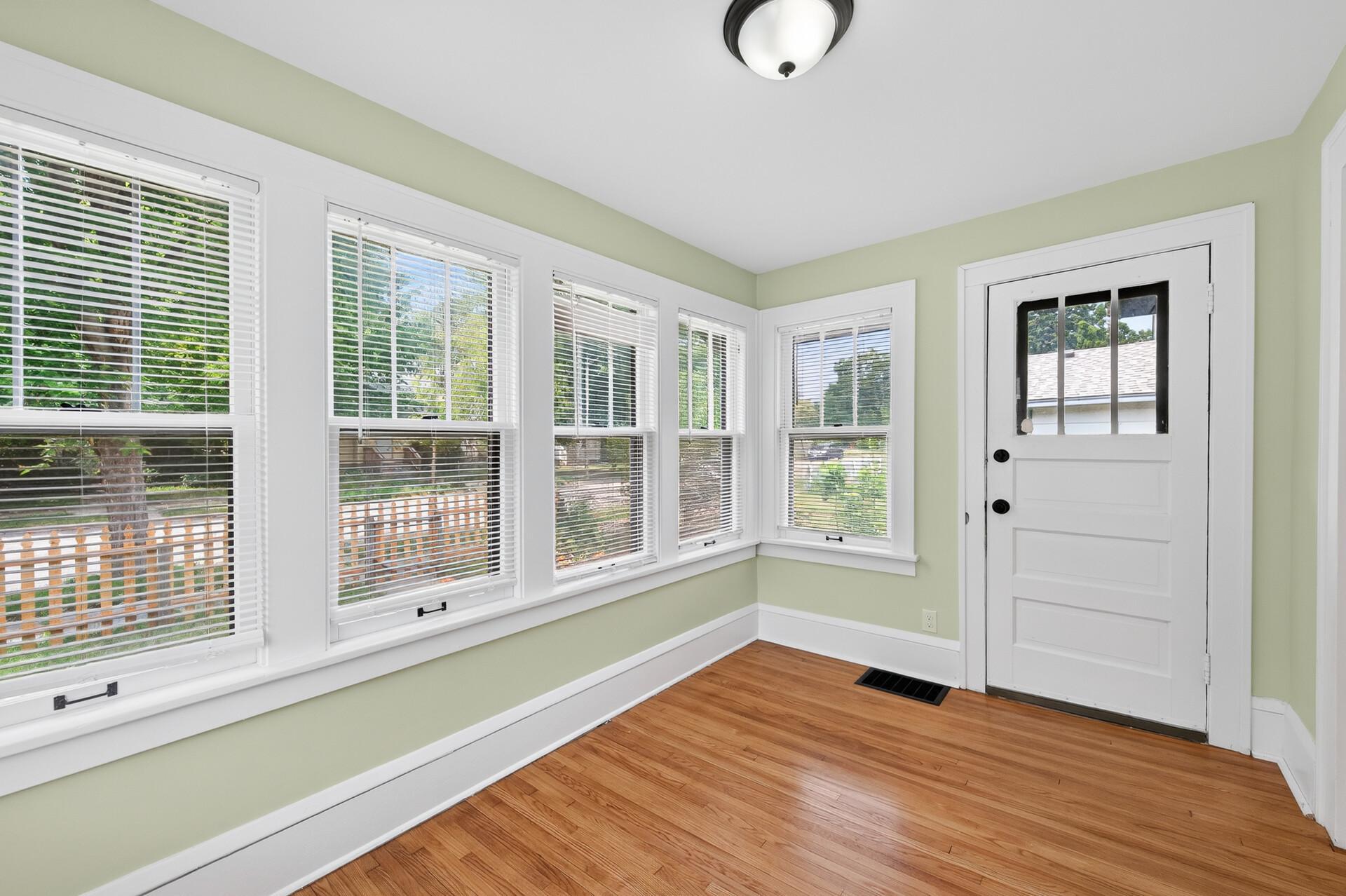 Bright enclosed front porch with abundant natural light