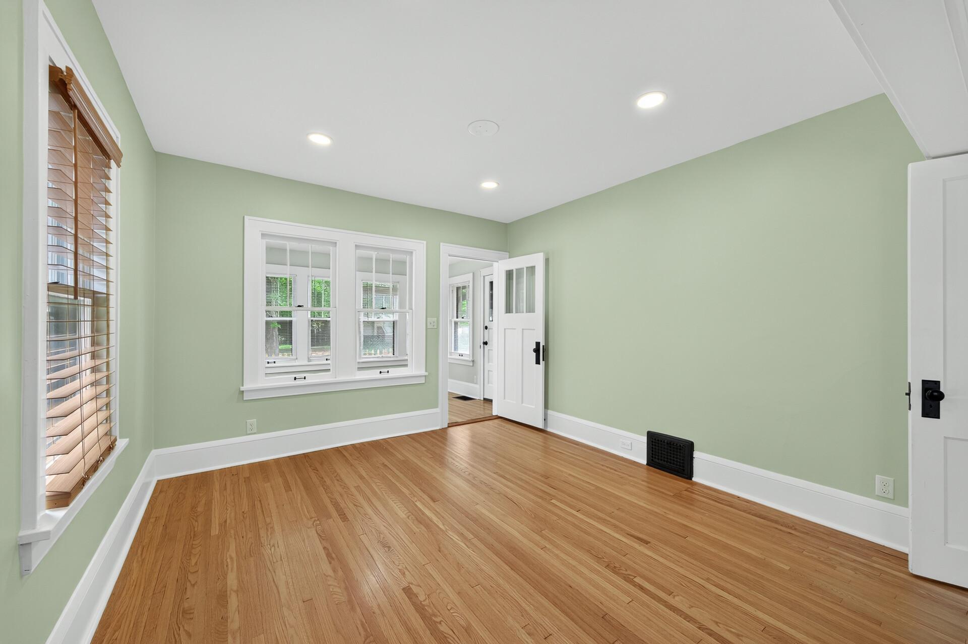 Spacious living room with beautiful refinished hardwood floors and recessed lighting