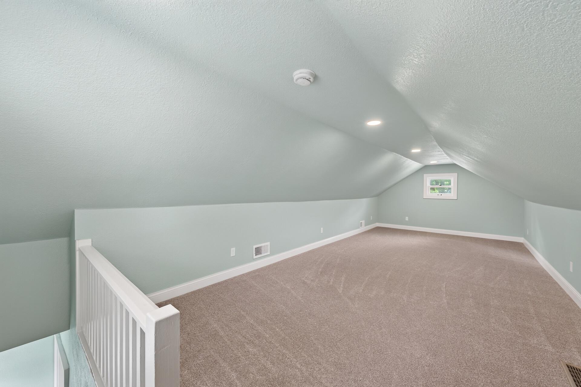 Upper-level room featuring fresh paint, new carpet, and newly added recessed lighting