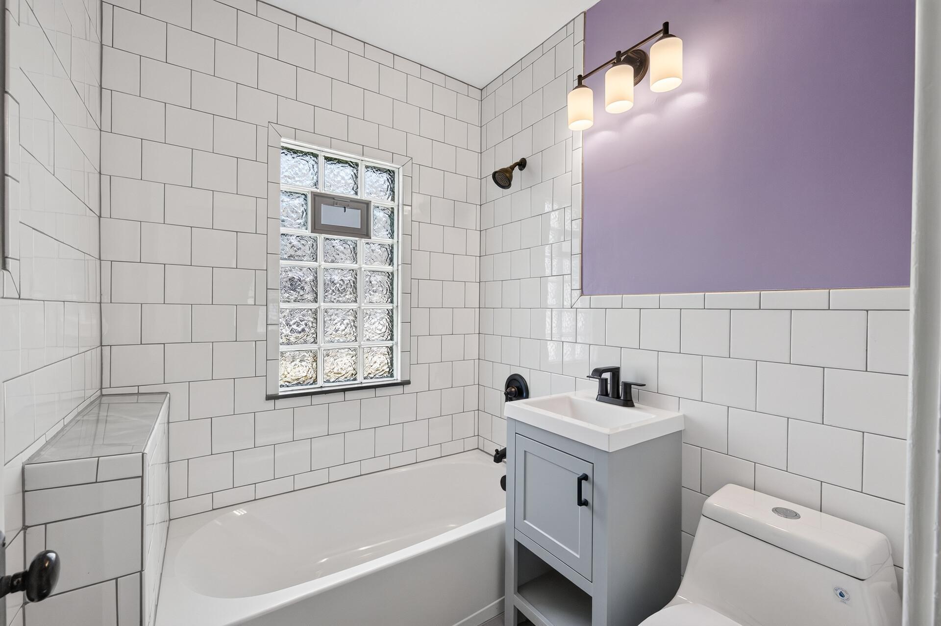 Updated full bathroom with tiled tub surround