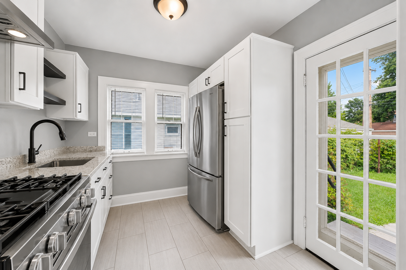 Kitchen with stainless steel refrigerator and ample cabinetry