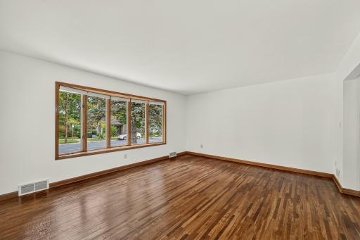 Large and bright living room with gleaming hardwood floors!