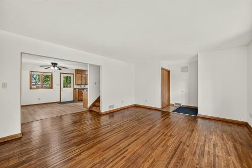 Living room, dining room and kitchen with door to fenced back yard.
