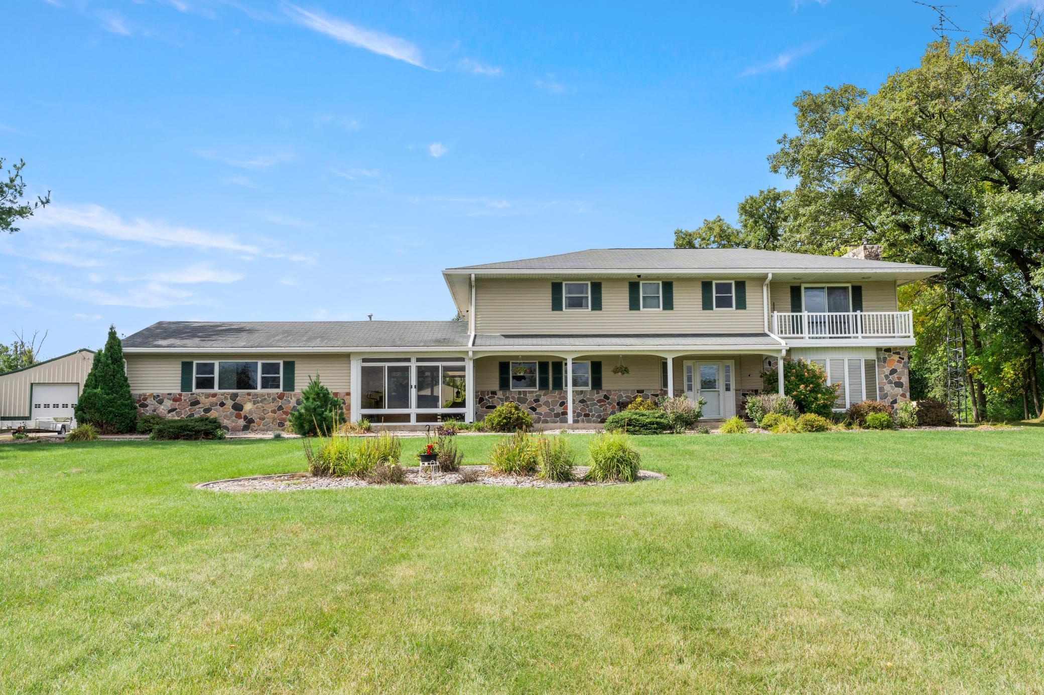 Screen room and front porch with lovely landscaping