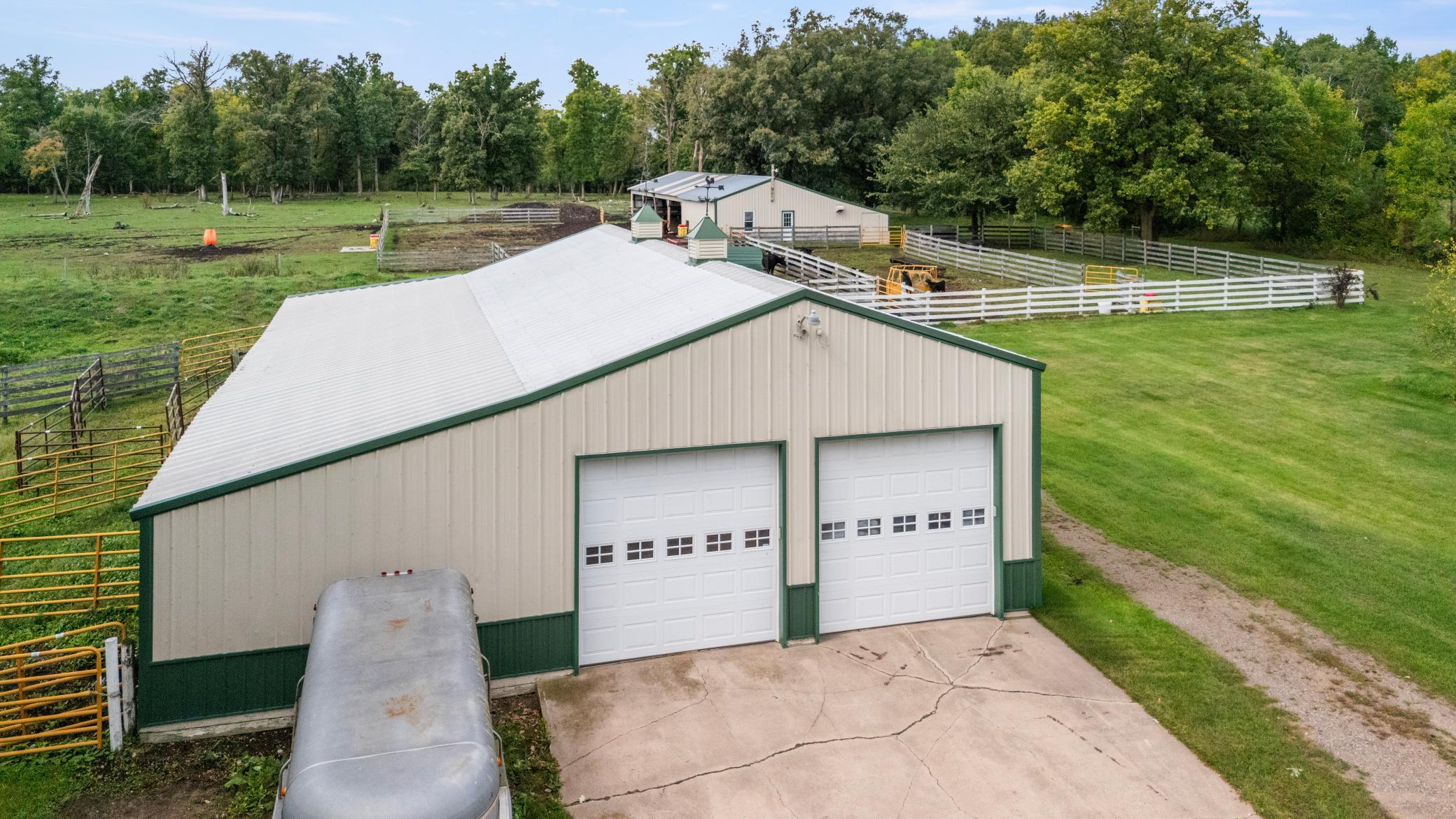 View of detached garage with cattle area in rear