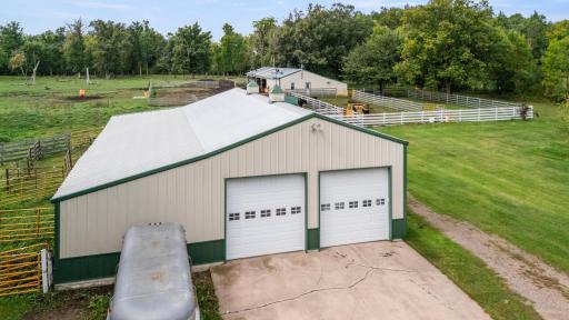 View of detached garage with cattle area in rear