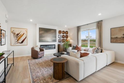 Open concept great room with generous family room, fireplace with shiplap detail.
