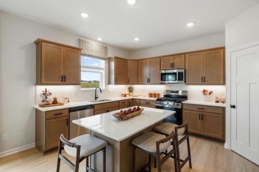 Warm stained cabinetry with center island. Kitchen sink with window views!