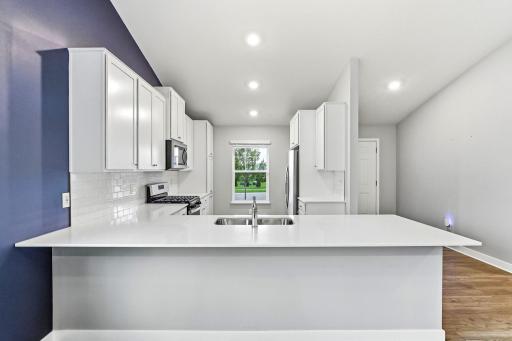 Center island, quartz countertops and stainless appliances.