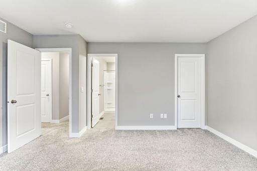Primary bedroom with 3/4 ensuite bath and walk in closet.