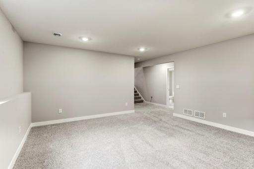 Lower level family room with view to staircase.
