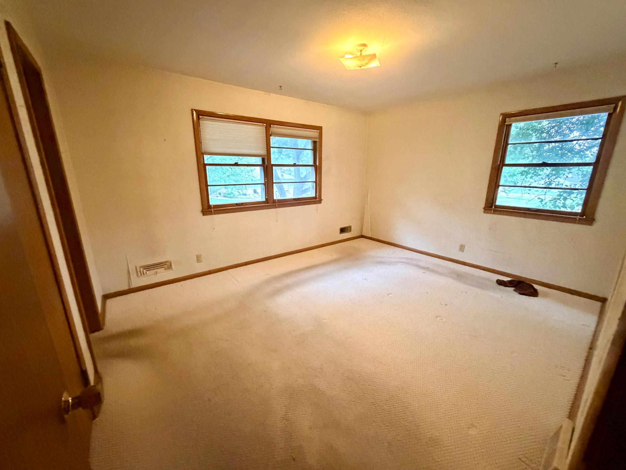 The corner primary bedroom has north and east-facing windows for great light and circulation.
