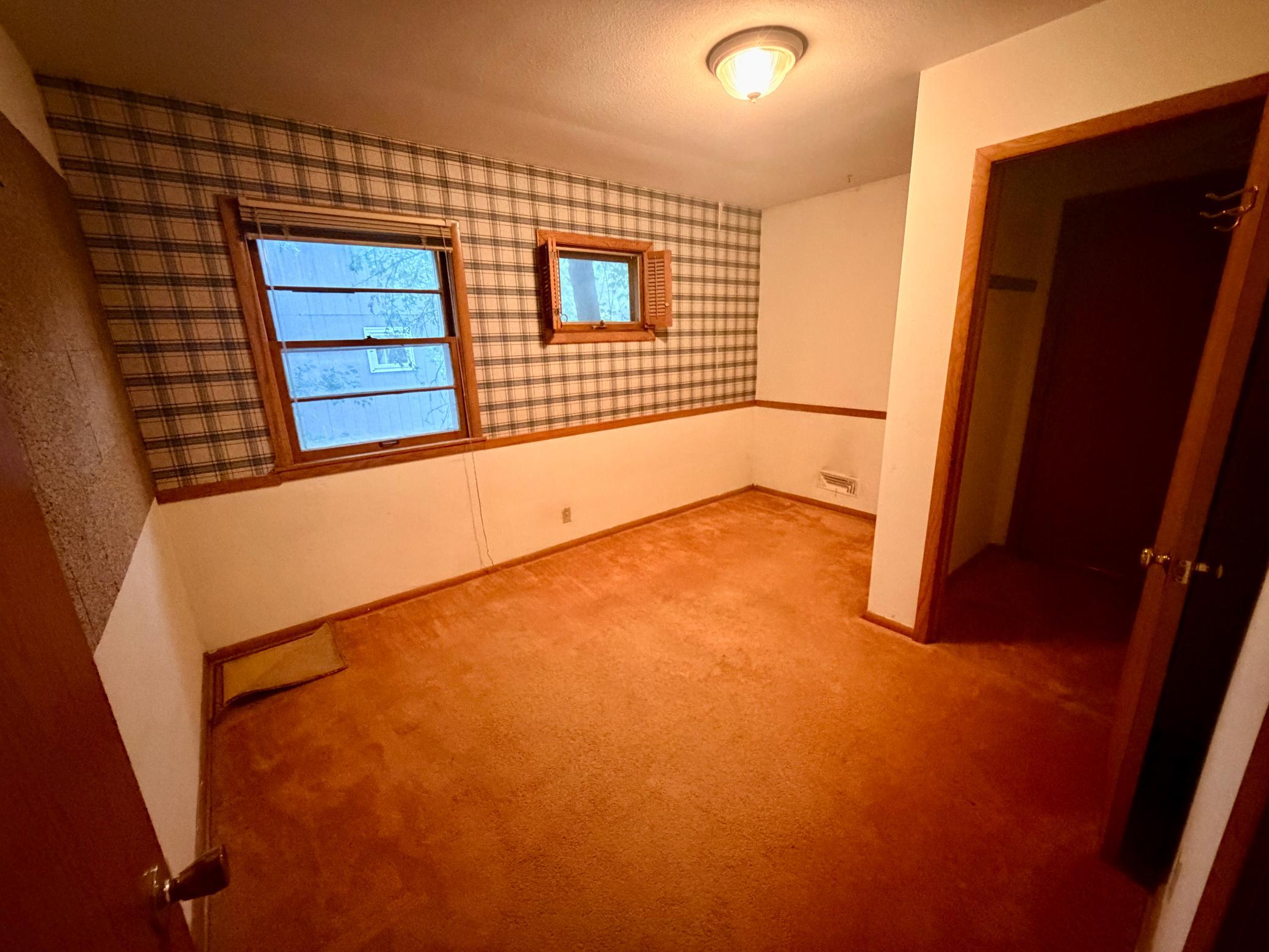 Bedroom 2 features two windows and a unique walk-through closet that is shared with bedroom 3.