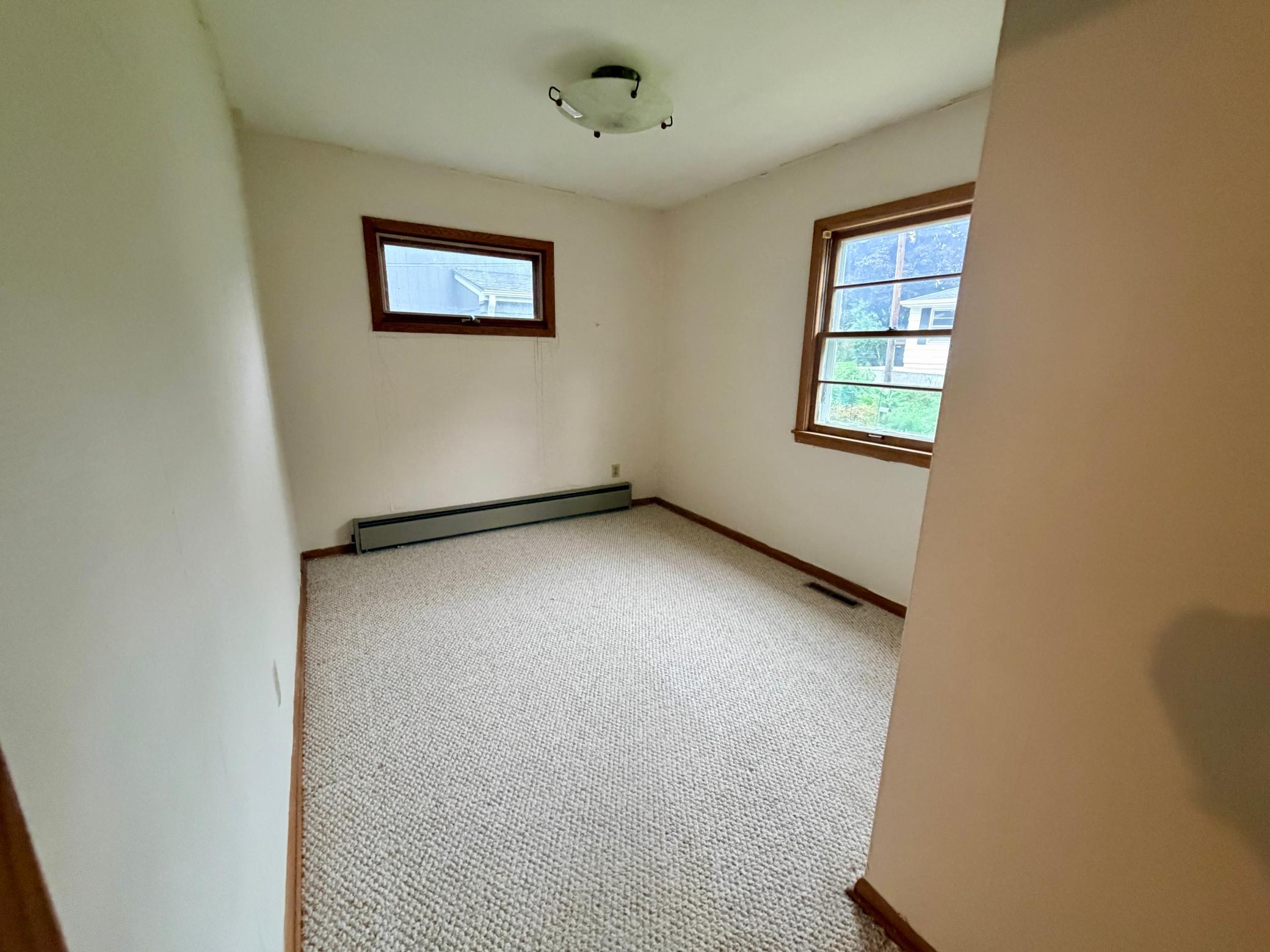 The corner bedroom 4 has east and south-facing windows and both forced air and supplemental baseboard heat.