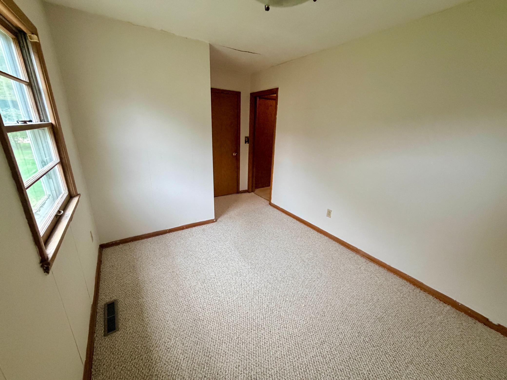 Bedroom for is in the corner with views of the back yard.